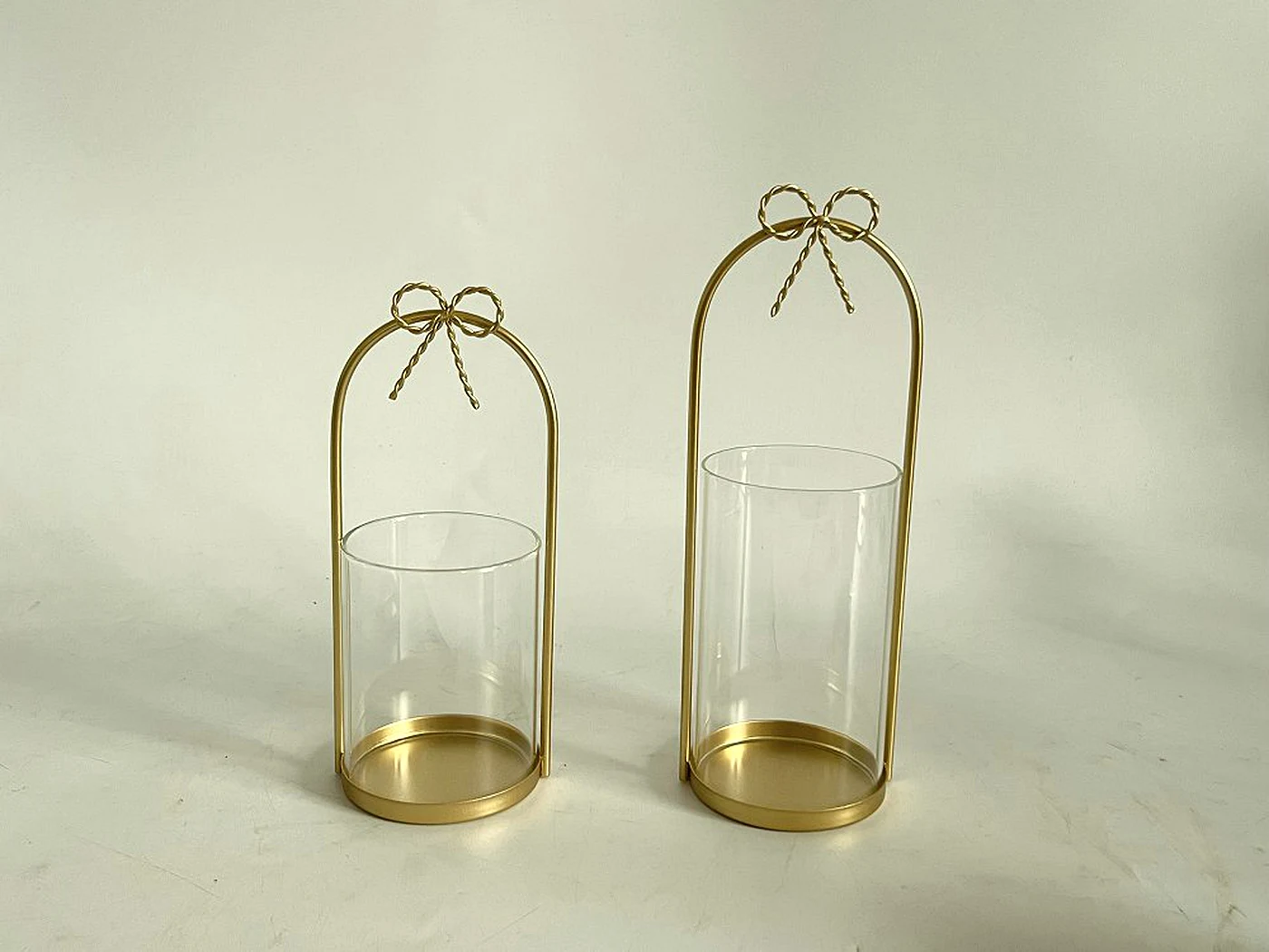 Pair of glass and brass bow lanterns
