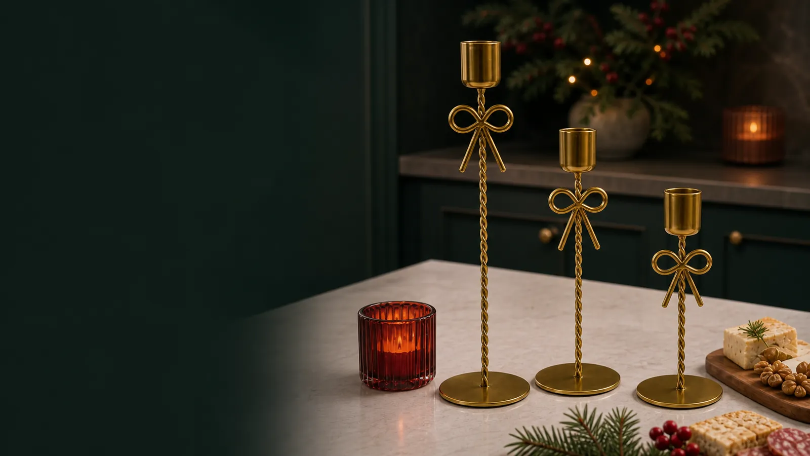 Three gold bow candle holders styled on a warm stone kitchen island