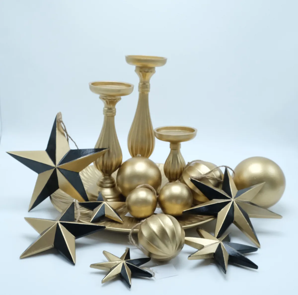 Gold stars, ornaments, and candle holders for a coordinated holiday collection