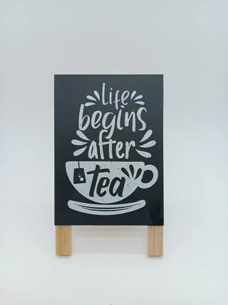 Black mini easel sign reading Life Begins After Tea