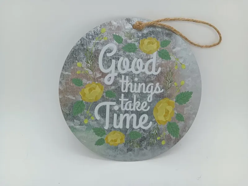Round galvanized iron sign reading Good Things Take Time