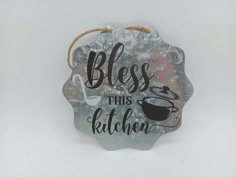 Scalloped galvanized iron sign reading Bless This Kitchen